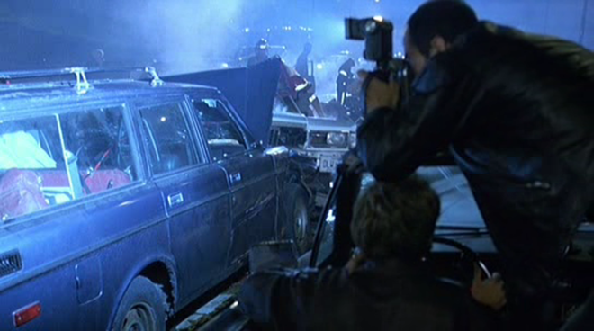 David Cronenberg and James Spader examine Rosanna Arquette's braces on the set of Crash